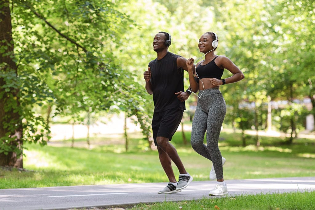 couple running on a paved trail