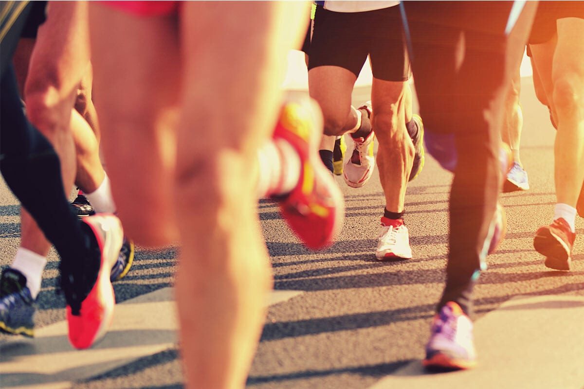 close up shot of runners' legs in a race