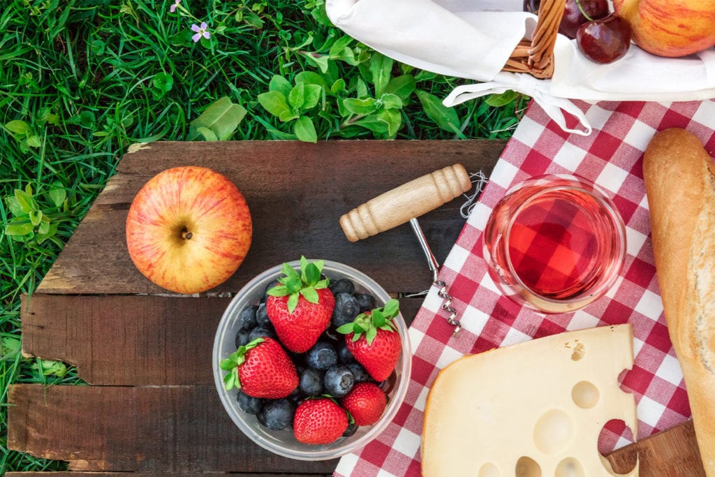 fruit and cheese on a picnic blanket