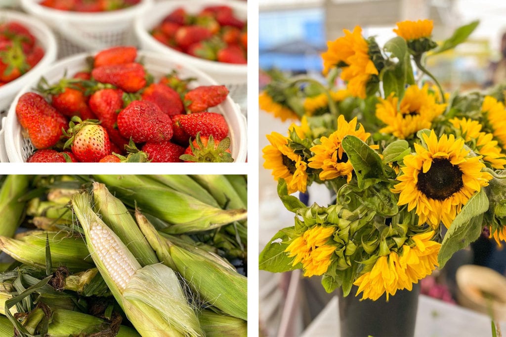 Vibrant strawberries in bowls, fresh corn on the cob, and bright sunflower bouquets create a colorful market display.