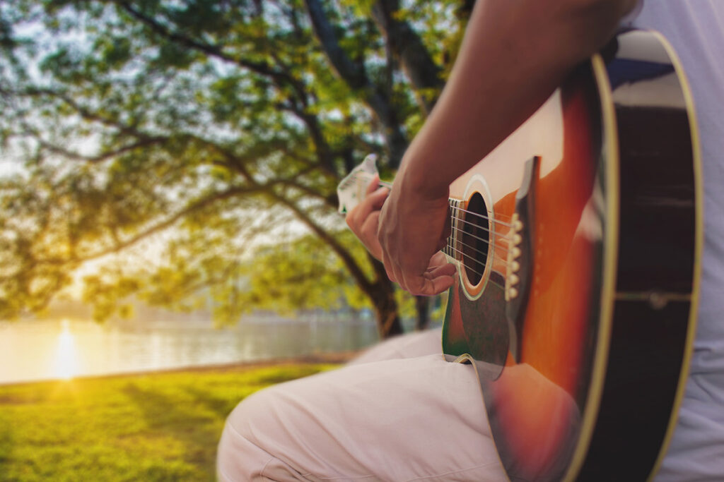 playing guitar by lake