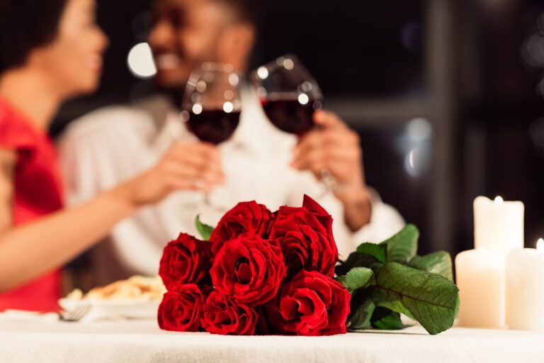 Couple celebrating Valentine's Day with wine and roses