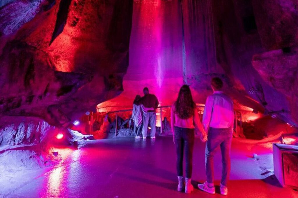 Couples standing in front of Ruby Falls waterfall.