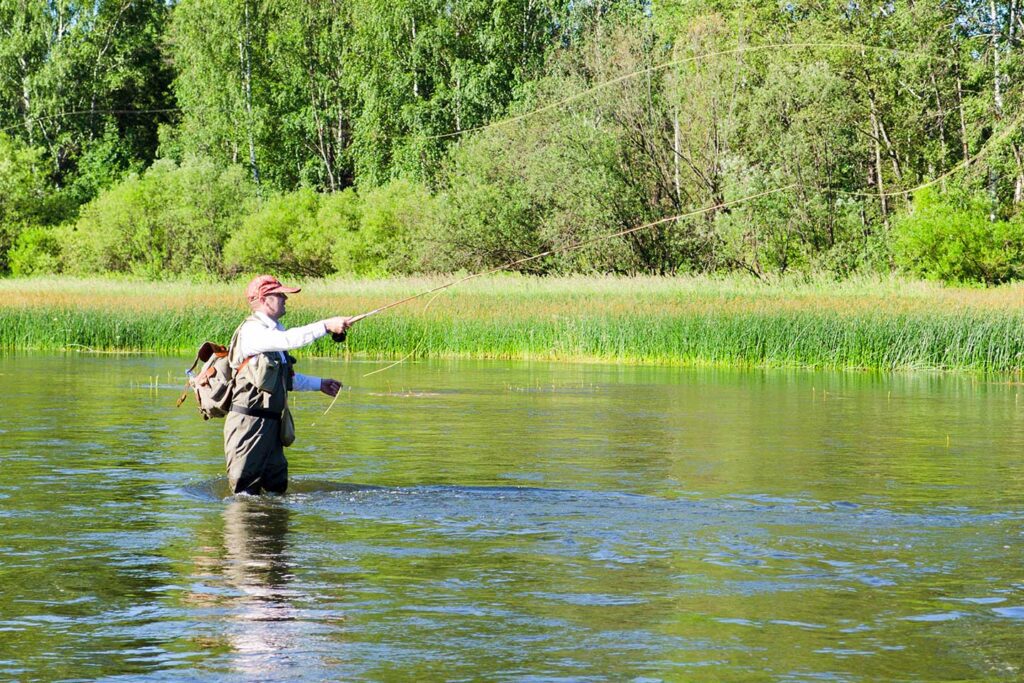 man fly fishing with gear from a fly fishing outfitter