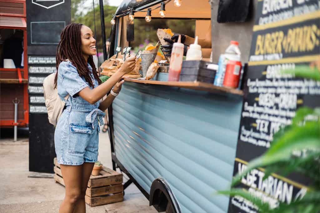 customer buying food from a street food vendor