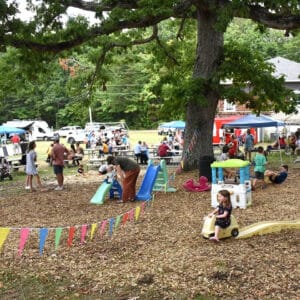 A picture of a birthday event with kids in the background playing.