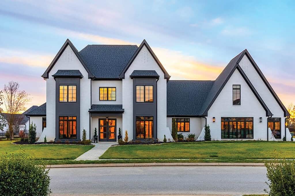 Bright living room with large windows, modern furnishings, and a cozy atmosphere featuring a neutral color palette.
