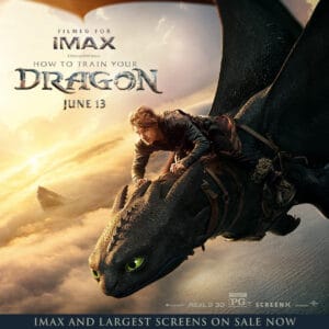A boy rides a dragon through a cloudy sky, promoting the IMAX release of "How to Train Your Dragon."