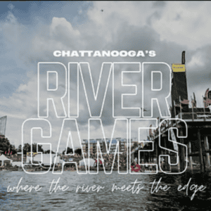 A vibrant river scene during Chattanooga's River Games, with crowds, festival flags, and a cloudy sky.
