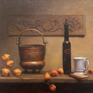 tea cup, bottle, and other kitchen tools are on a table.