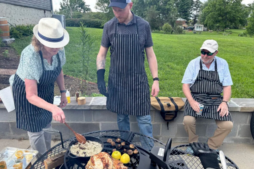 people pioneer cooking on fire