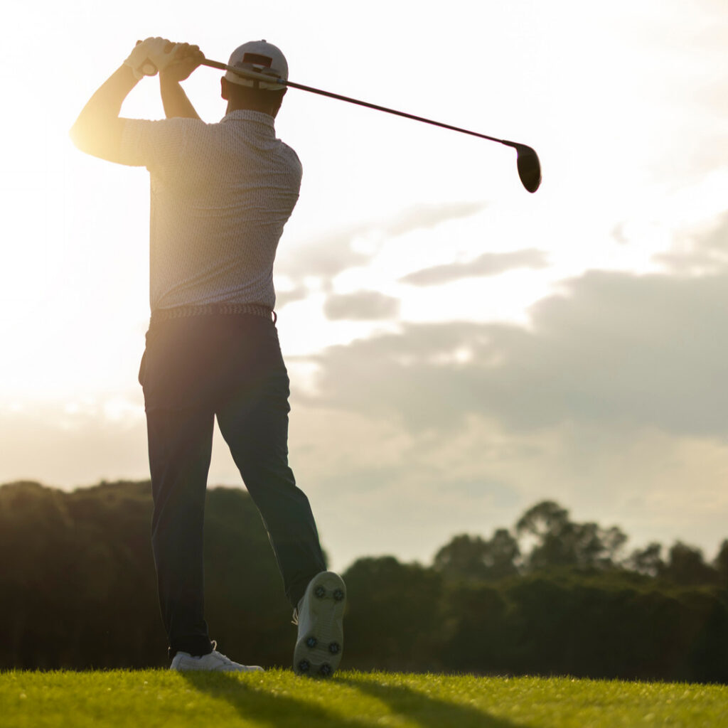 Golfer swinging club
