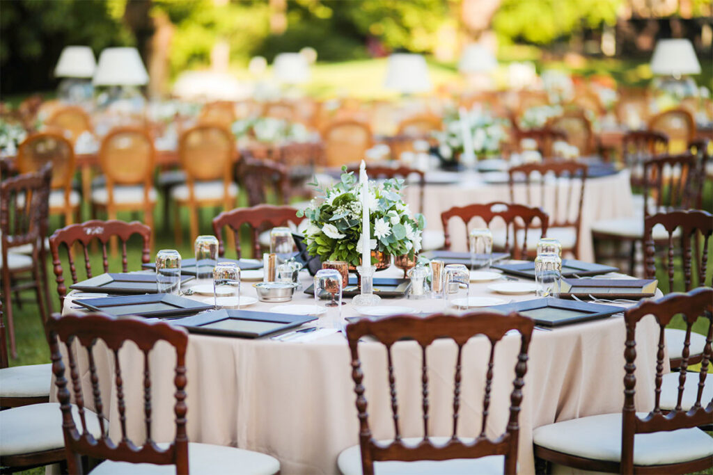 Wedding Table setup with wooden chairs in outdoor setting